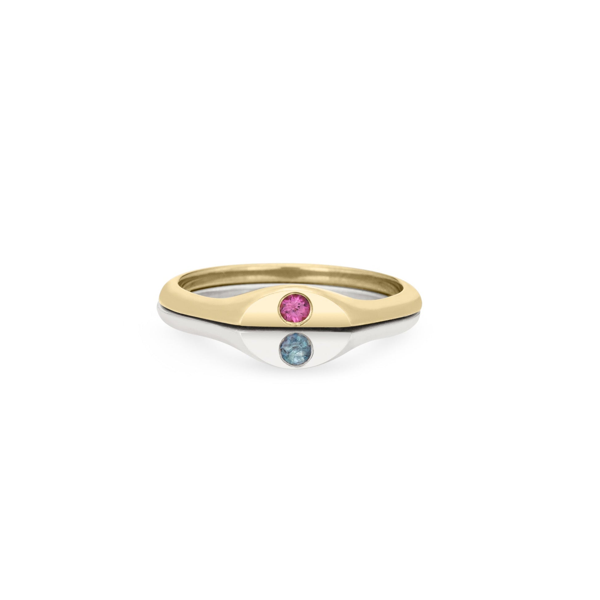 Half solid 14k gold and half sterling silver ring with two flush-set birthstones on a white background