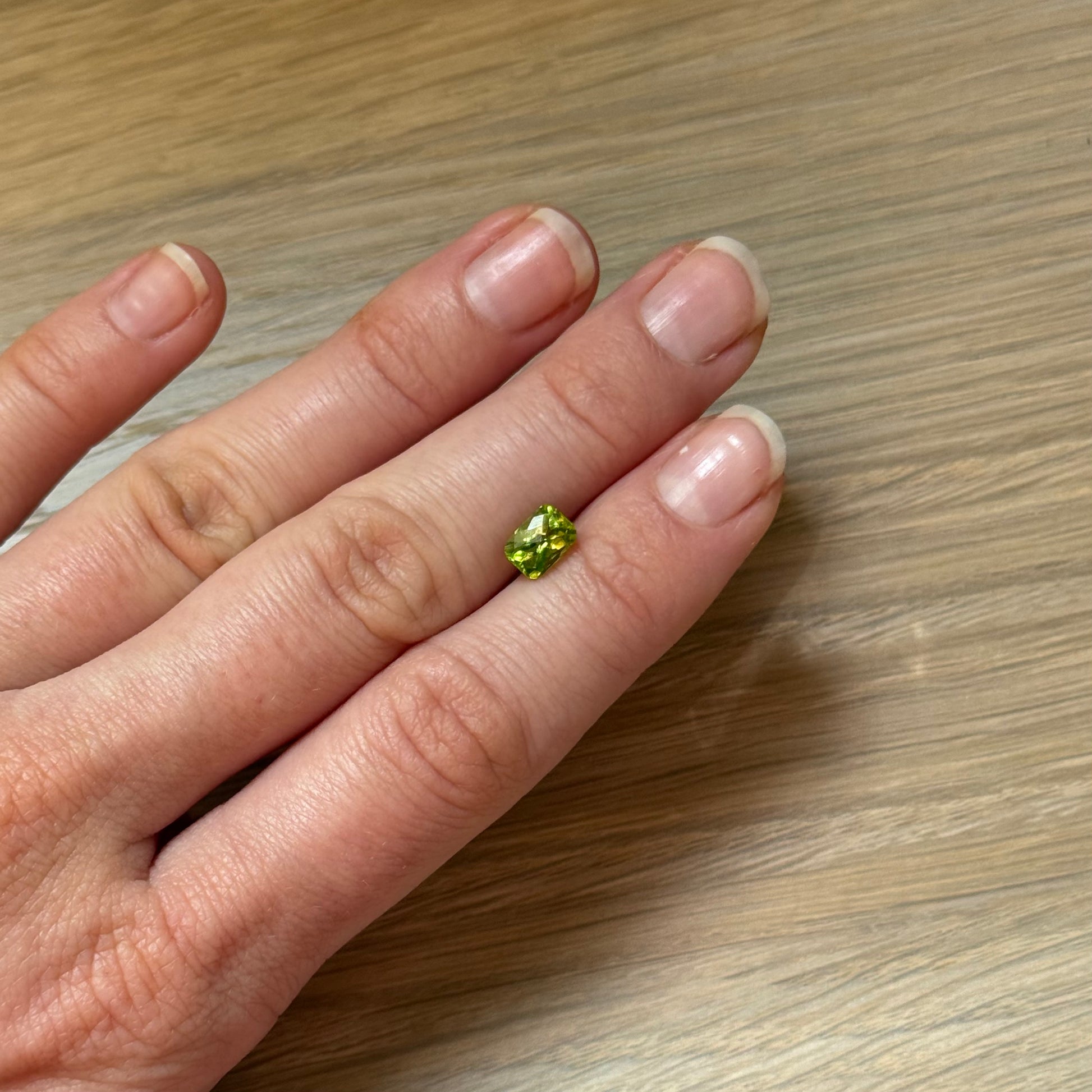 Hand with a green peridot gemstone 