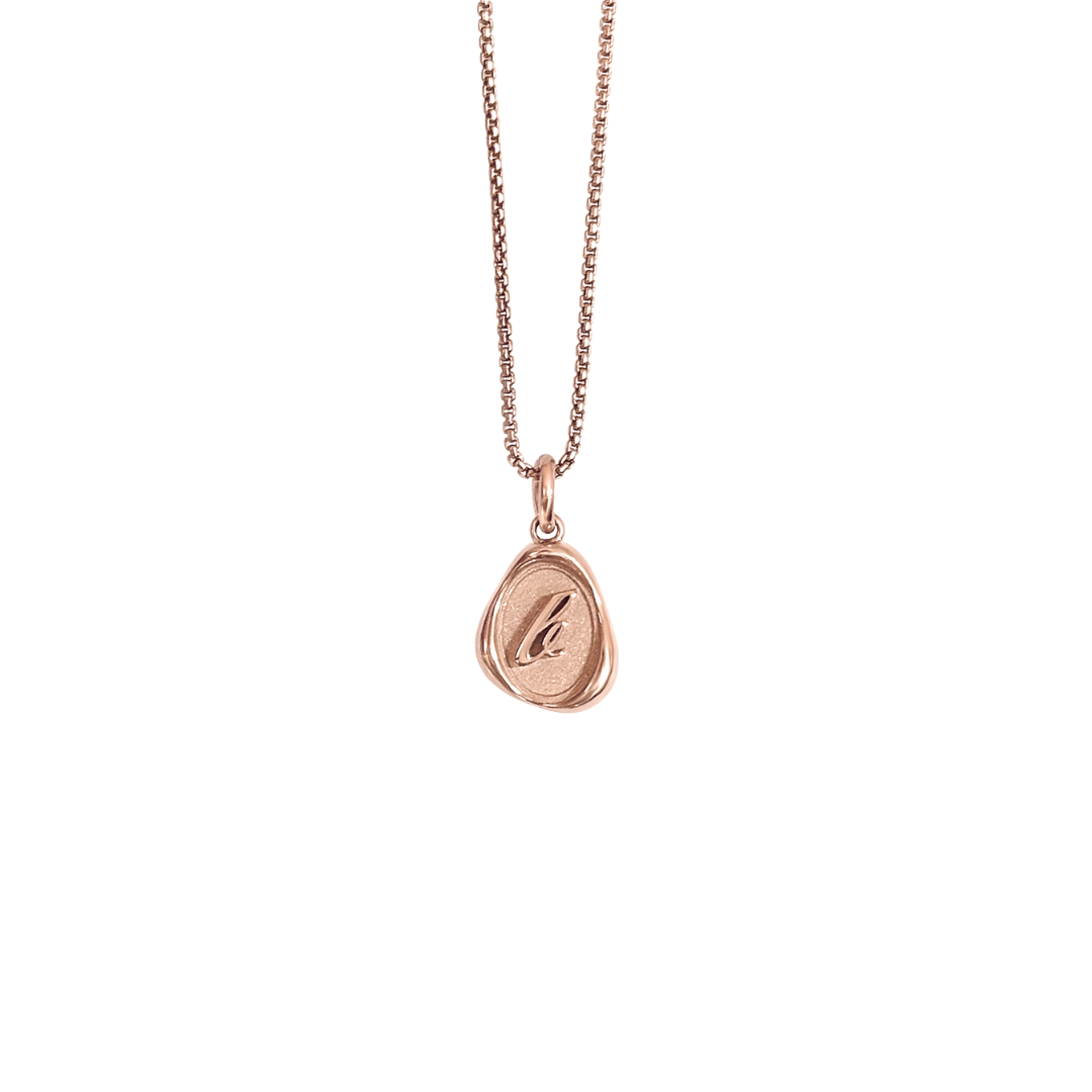 Solid 14k gold charm necklace with custom initial on white background