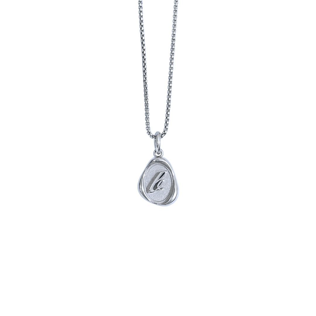 Solid 14k gold charm necklace with custom initial on white background