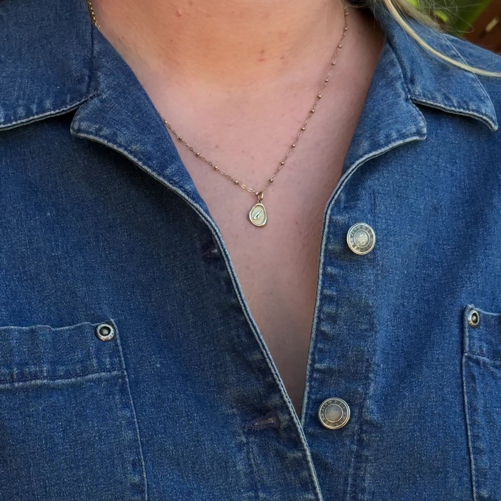 Solid 14k gold charm necklace with custom initial on model